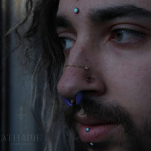 Load image into Gallery viewer, solid yellow gold diamond cut cable chain draped across two nostril piercings
